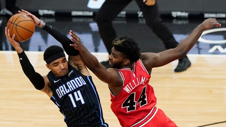 Orlando Magic guard Gary Harris, left, pulls in a rebound next to Chicago Bulls forward Patrick Williams during the second half of an NBA basketball game in Chicago, Wednesday, April 14, 2021. (AP Photo/Nam Y. Huh)