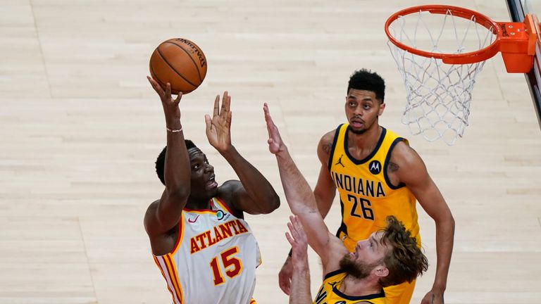 Atlanta Hawks' Clint Capela (15) shoots and scores against Indiana Pacers' Domantas Sabonis (11) during the second half of an NBA basketball game against the Indiana Pacers on Sunday, April 18, 2021, in Atlanta. (AP Photo/Brynn Anderson) 
