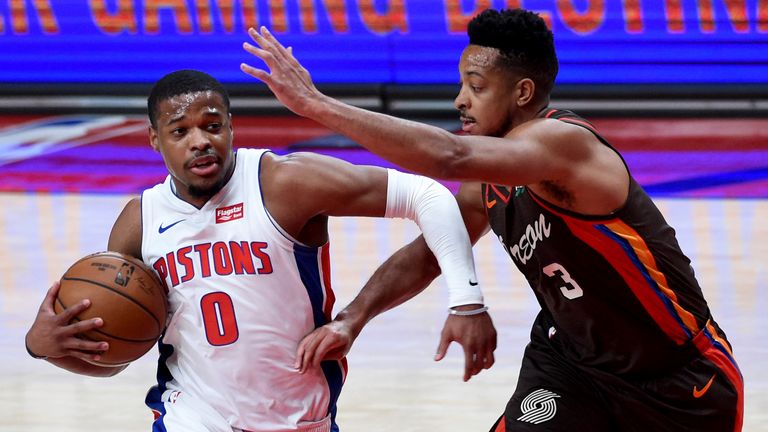 Detroit Pistons guard Dennis Smith Jr., left, drives to the basket on Portland Trail Blazers guard CJ McCollum during the first half of an NBA basketball game in Portland, Ore., Saturday, April 10, 2021. 