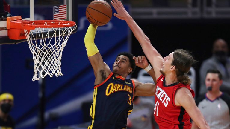 Golden State Warriors guard Jordan Poole, left, shoots next to Houston Rockets center Kelly Olynyk during the first half of an NBA basketball game in San Francisco, Saturday, April 10, 2021. 