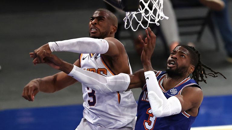 Nerlens Noel, right, of the New York Knicks is fouled by Chris Paul, left, of the Phoenix Suns in the first half of an NBA basketball game Monday, April 26, 2021, in New York.