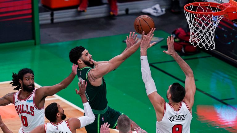 Boston Celtics forward Jayson Tatum, center, drives to the basket against the Chicago Bulls defense during the first half of an NBA basketball game, Monday, April 19, 2021, in Boston. (AP Photo/Charles Krupa)


