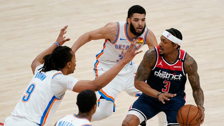 Washington Wizards guard Bradley Beal, right, protects the ball as he is pressured by Oklahoma City Thunder center Moses Brown (9), guard Theo Maledon (11) and forward Kenrich Williams in the first half of an NBA basketball game, Monday, April 19, 2021, in Washington. (AP Photo/Patrick Semansky) 