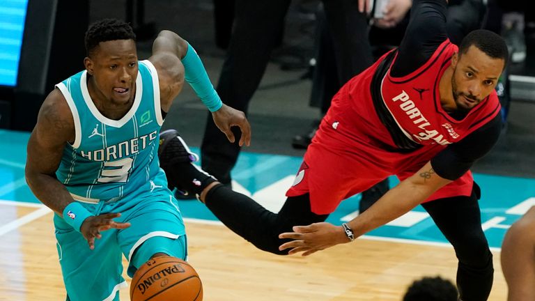 Charlotte Hornets guard Terry Rozier drives past Portland Trail Blazers forward Norman Powell during the second half in an NBA basketball game on Sunday, April 18, 2021, in Charlotte, N.C. (AP Photo/Chris Carlson) 