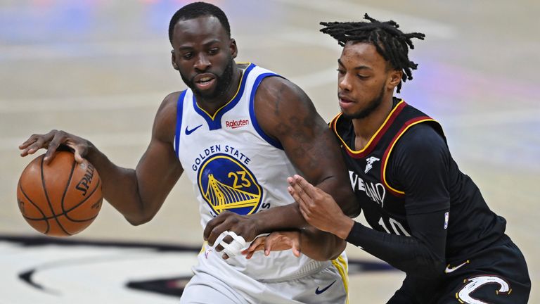 Golden State Warriors&#39; Draymond Green (23) drives on Cleveland Cavaliers&#39; Darius Garland (10) during the second half of an NBA basketball game Thursday, April 15, 2021, in Cleveland. (AP Photo/David Dermer)


