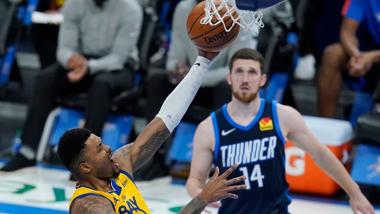 Golden State Warriors forward Kent Bazemore (26) shoots in front of Oklahoma City Thunder guard Svi Mykhailiuk (14) in the second half of an NBA basketball game Wednesday, April 14, 2021, in Oklahoma City. (AP Photo/Sue Ogrocki)