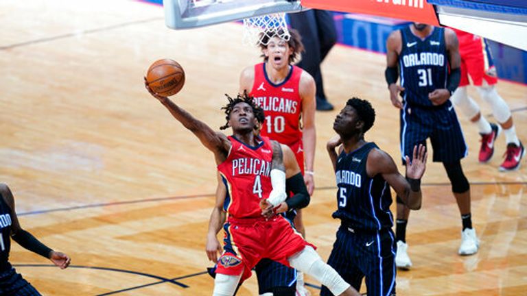 AP - New Orleans Pelicans forward Wes Iwundu (4) goes to the basket against Orlando Magic center Mo Bamba (5) 