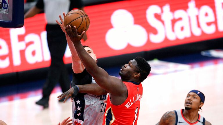 AP - New Orleans Pelicans forward Zion Williamson (1) goes to the basket against Washington Wizards center Alex Len (27) and guard Bradley Beal,