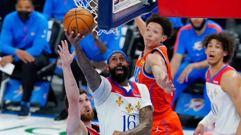 AP - New Orleans Pelicans forward James Johnson (16) goes to the basket between Oklahoma City Thunder guard Svi Mykhailiuk, left, and center Isaiah Roby