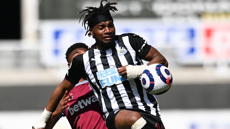 Newcastle...s Allan Saint-Maximin kicks the ball away from West Ham's Ben Johnson, left, during the English Premier League soccer match between Newcastle United and West Ham United at St James' Park, Newcastle, England, Saturday April 17, 2021. (AP Photo/Stu Forster/Pool)..