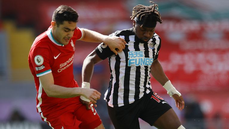 Ozan Kabak tussles with Allan Saint-Maximin during Liverpool's match against Newcastle