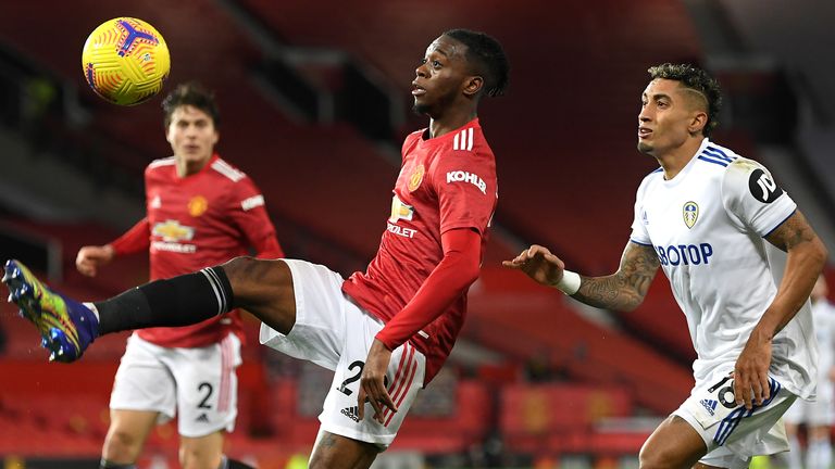 Manchester United's Aaron Wan-Bissaka (left) and Leeds United's Raphinha battle for the ball during the Premier League match at Old Trafford