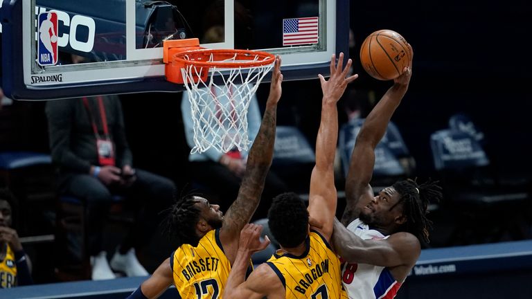 Detroit Pistons&#39; Isaiah Stewart (28) goes up for a dunk against Indiana Pacers&#39; Oshae Brissett (12) and Malcolm Brogdon (7) during the second half of an NBA basketball game, Saturday, April 24, 2021, in Indianapolis. (AP Photo/Darron Cummings)


