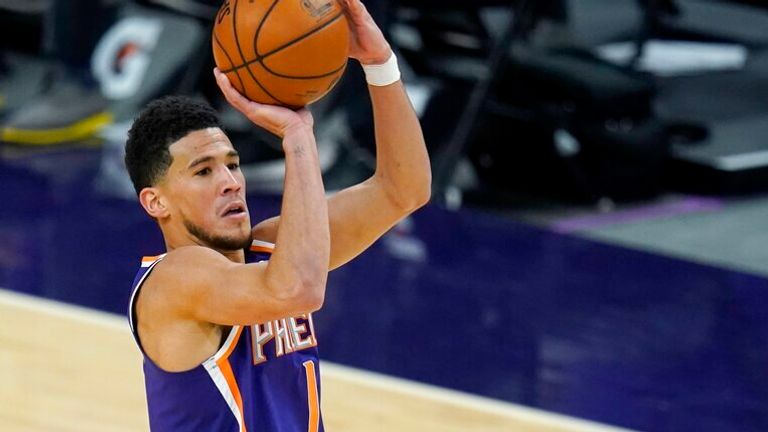 AP - Phoenix Suns guard Devin Booker (1) shoots over Chicago Bulls forward Patrick Williams (44)