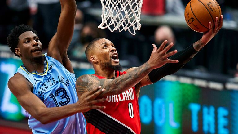 AP - Portland Trail Blazers guard Damian Lillard (0) shoots over Memphis Grizzlies forward Jaren Jackson Jr. (13) 