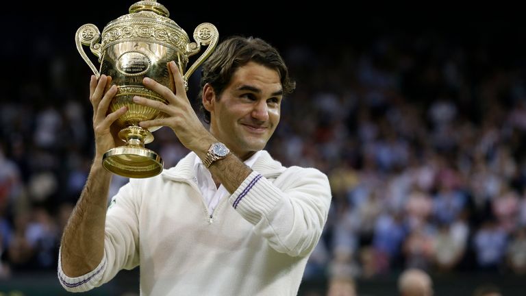 Roger Federer of Switzerland celebrates with the trophy after winning the men's singles final against Andy Murray of Britain at the All England Lawn Tennis Championships at Wimbledon, England, Sunday, July 8, 2012. (AP Photo/Kirsty Wigglesworth) 