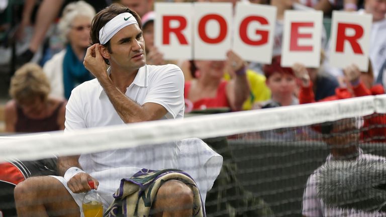 Roger Federer of Switzerland rests between sets during a first round men's singles match against Albert Ramos of Spain at the All England Lawn Tennis Championships at Wimbledon, England, Monday, June 25, 2012. (AP Photo/Tim Hales) 