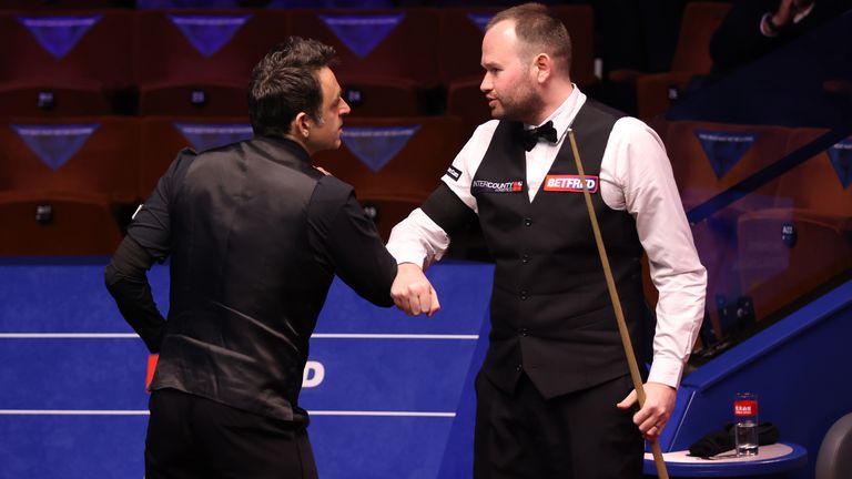 O'Sullivan (L) and Mark Joyce (R) bump elbows ahead of their first round encounter