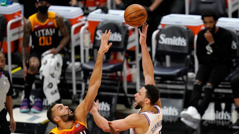 Philadelphia 76ers guard Ben Simmons shoots as Utah Jazz center Rudy Gobert defends