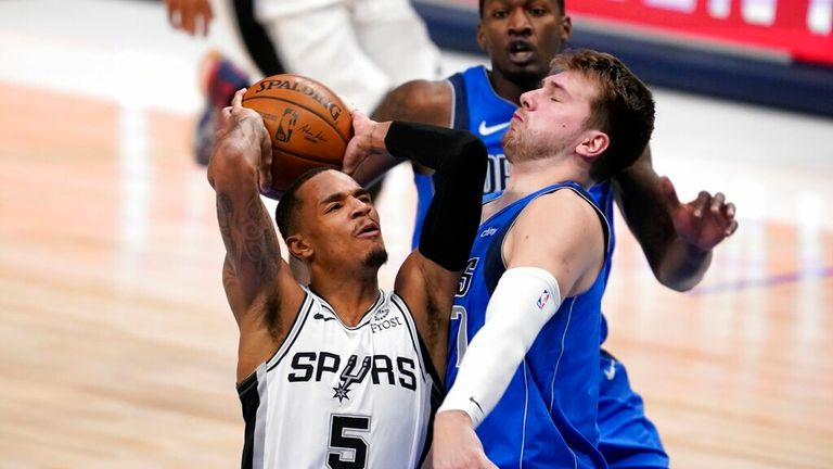 AP - San Antonio Spurs guard Dejounte Murray, left, drives against Dallas Mavericks guard Luka Doncic