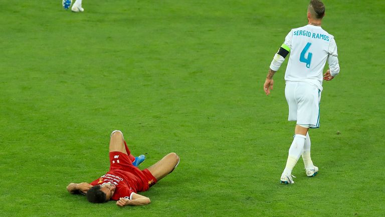 Liverpool&#39;s Mohamed Salah (left) lies injured on the pitch after a challenge from Real Madrid&#39;s Sergio Ramos during the UEFA Champions League Final