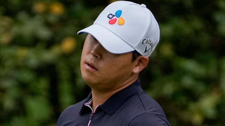 Is Woo Kim, of South Korea, reacts to a missed putt on the 10th green during the second round of the Masters golf tournament on Friday, April 9, 2021, in Augusta, Ga. (AP Photo/Gregory Bull)
