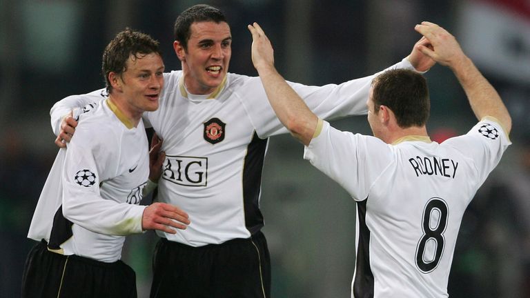 Ole Gunnar Solskjaer and John O'Shea celebrate with Wayne Rooney after his equaliser against Roma in the Stadio Olimpico