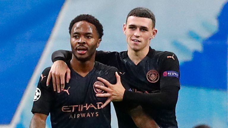 Manchester City's Raheem Sterling, second left, is congratulated by teammate Phil Foden after scoring his team's third goal during the Champions League Group C soccer match between Marseille and Manchester City at Stade Velodrome in Marseille, France, Tuesday, Oct. 27, 2020. (Guillaume Horcajuelo/Pool via AP)