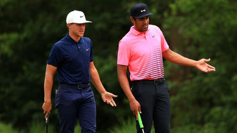 Tony Finau and Cameron Champ talk over a shot on the fourth green during the second round of the Zurich Classic of New Orleans at TPC Louisiana
