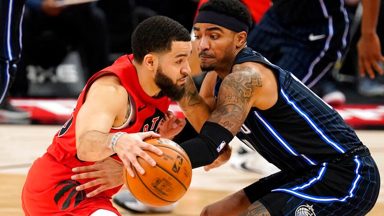 AP - Toronto Raptors guard Fred VanVleet (23) drives into Orlando Magic guard Gary Harris (14)