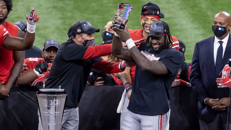 Sermon holds up the MVP trophy after his 331 rushing yards against Northwestern in the Big Ten Championship game. (Cal Sport Media via AP Images)
