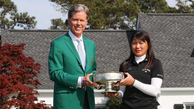 Masters Chairman Fred Ridley presents Tsubasa Kajitani of Japan with the winner's cup after the final round of the Augusta National Women's Amateur at Augusta National Golf Club 