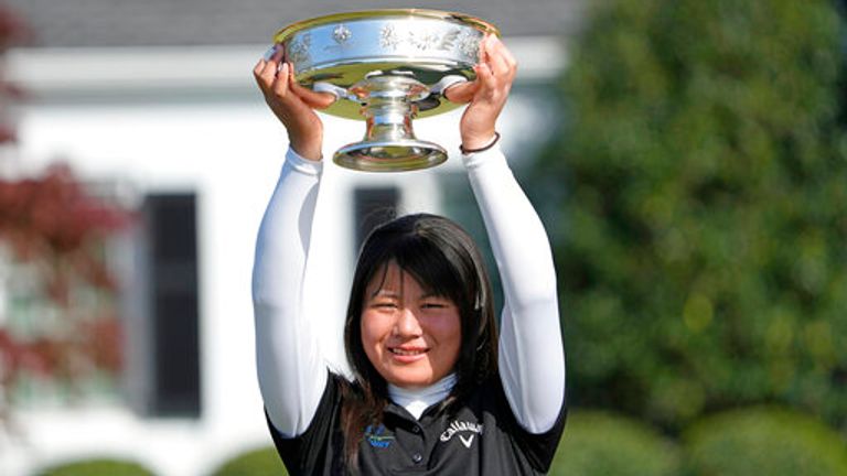 Tsubasa Kajitani, of Japan, holds up the trophy after winning the Augusta National Women's Amateur golf tournament at Augusta National Golf Club