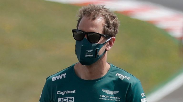 Aston Martin driver Sebastian Vettel of Germany, center, walks inspecting the track ahead of the Portugal Formula One Grand Prix at the Algarve International Circuit near Portimao, Portugal, Thursday, April 29, 2021. The Portugal Grand Prix will be held on Sunday. 