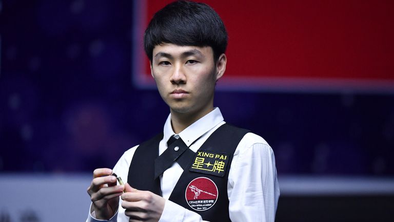 Xu Si of China chalks his cue as he considers a shot Stephen Maguire of Scotland in the first round match during the Xingpai Group 2019 World Snooker China Open in Beijing, China, 2 April 2019. Stephen Maguire defeated Xu Si 6-1. (Imaginechina via AP Images)