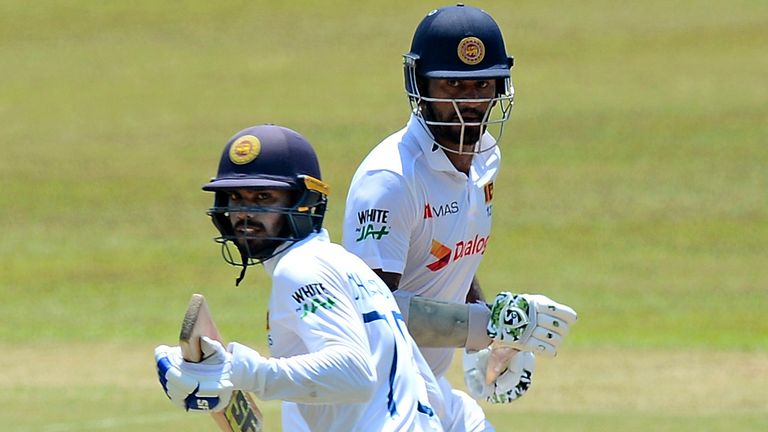 Sri Lankan batsman Dhanajaya De Silva ,left and Dimuth Karunaratna ,right,  run between wickets during the fourth day of the first test cricket match between Sri Lanka and Bangladesh in Pallekele, Sri Lanka, Saturday, April 24, 2021.( AP Photo/Sameera Peiris)