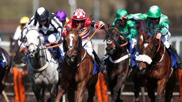 Jack Kennedy riding Tronador (centre right) go to the front at Aintree