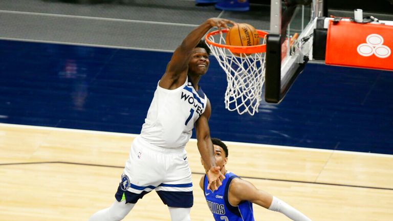 Minnesota Timberwolves forward Anthony Edwards (1) dunks in front of Dallas Mavericks guard Tyler Bey (2) in the fourth quarter of an NBA basketball game, Sunday, May 16, 2021, in Minneapolis. The Timberwolves defeated the Mavericks 136-121. (AP Photo/Andy Clayton-King)