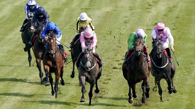 William Buick riding Wirko (left, blue) win the Blue Riband Trial at Epsom Downs 
