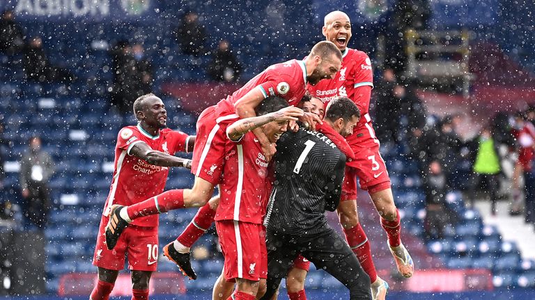 Alisson is mobbed after scoring a late winner for Liverpool at West Brom