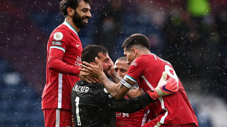 Alisson celebrates his late winner against West Brom with teammates
