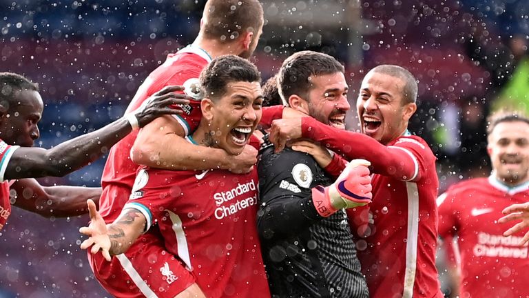 Alisson is mobbed by teammates after scoring an stoppage-time winner (AP)