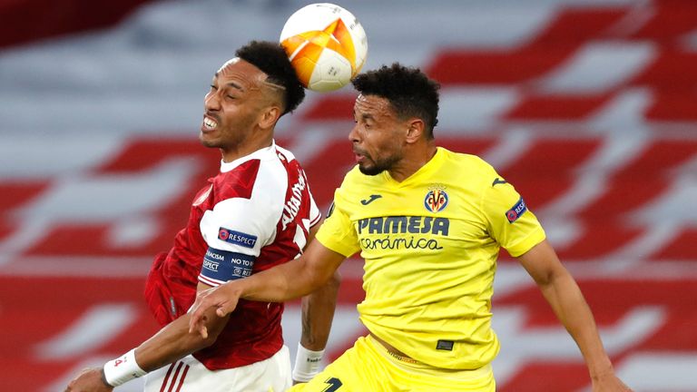 Arsenal's Pierre-Emerick Aubameyang, left, and Villareal's Francis Coquelin challenge for the ball during the Europa League semifinal second leg soccer match between Arsenal and Villarreal at the Emirates stadium in London, England, Thursday, May 6, 2021. (AP Photo/Alastair Grant)