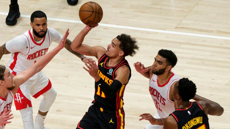 Atlanta Hawks guard Trae Young (11) shoots against the Houston Rockets during the first half of an NBA basketball game on Sunday, May 16, 2021, in Atlanta. (AP Photo/Ben Gray)