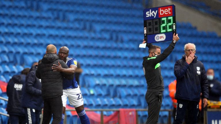 Bamba gets a hug from Rotherham boss Paul Warne as he enters the game in the final minute of stoppage-time