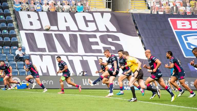 Picture by Allan McKenzie/SWpix.com - 09/08/2020 - Rugby League - Betfred Super League - Salford Red Devils v Hull FC - Emerald Headingley Stadium, Leeds, England - Marc Sneyd kicks off, Black Lives Matter flag, banner.