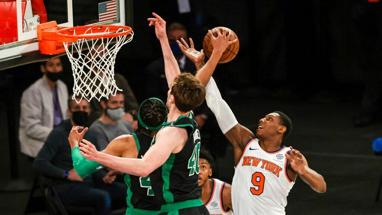 Boston Celtics center Luke Kornet (40) battles for the ball against New York Knicks guard RJ Barrett (9) during the second half of an NBA basketball game in New York, Sunday, May 16, 2021. (Vincent Carchietta/Pool Photo via AP)