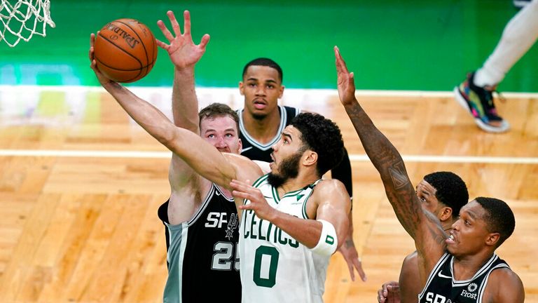AP - Boston Celtics forward Jayson Tatum (0) goes to the hoop against San Antonio Spurs center Jakob Poeltl (25)