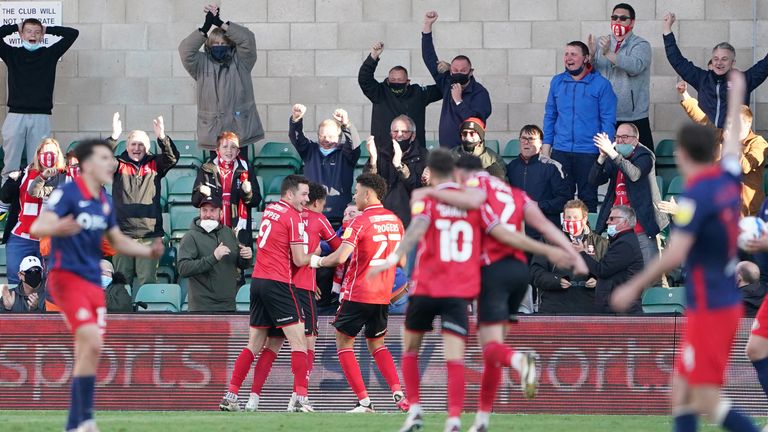 Lincoln City's Brennan Johnson celebrates scoring the second goal of the game in front of the fans
