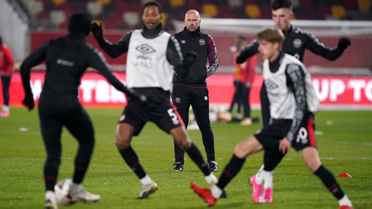 Brentford's Neil MacFarlane oversees the warm-up on the pitch before the club's FA Cup third-round tie against Middlesbrough